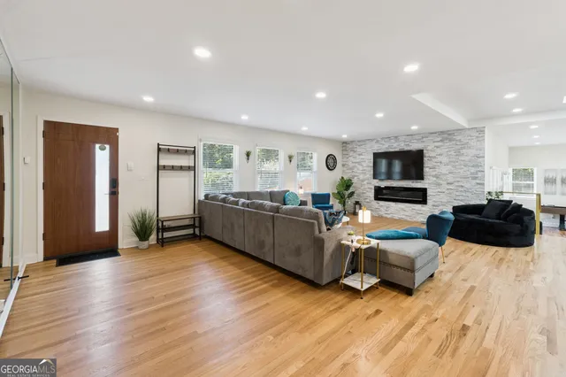 a living room with furniture and wooden floor