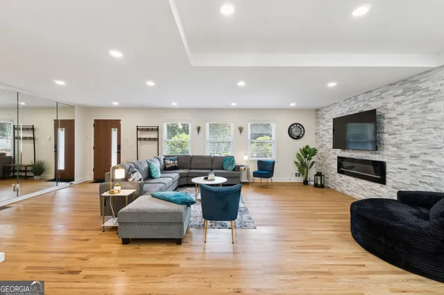 a living room with furniture and wooden floor