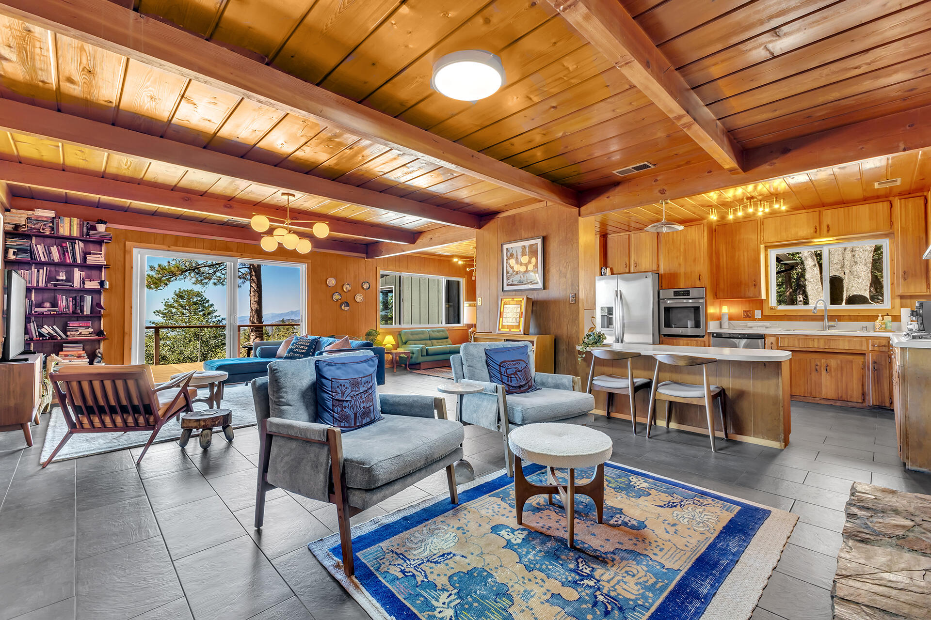 52300 Sylvan Way Idyllwild, CA 92549 - Photo 5 of 88 a living room with furniture a rug kitchen view and a large window