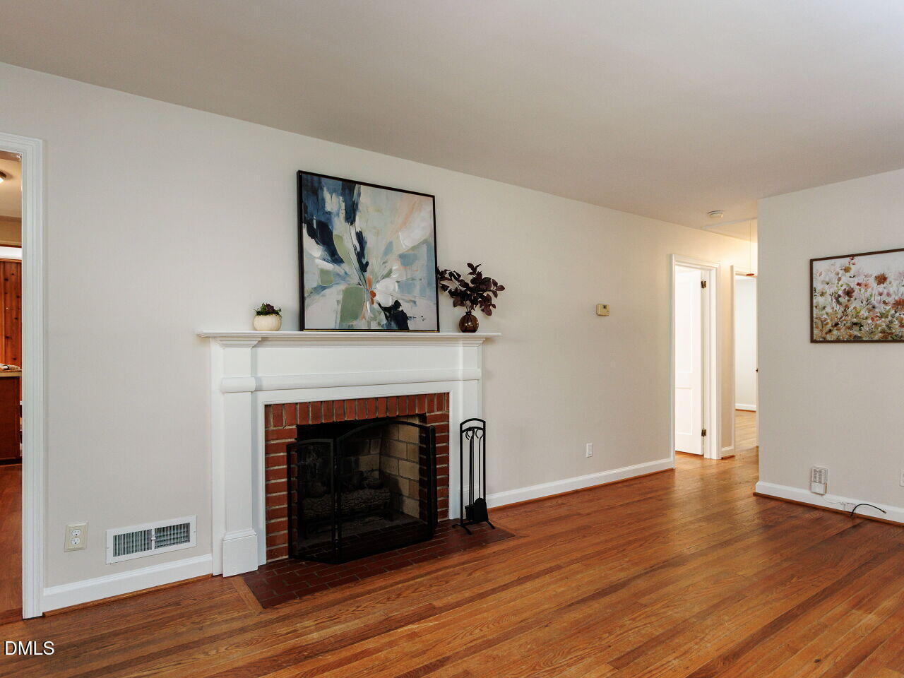 1332 Banbury Road Raleigh, NC 27607 - Photo 10 of 46 a view of a livingroom with wooden floor and a fireplace