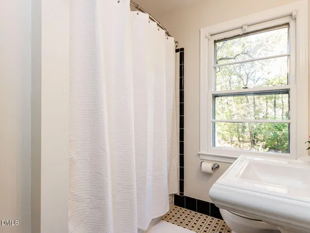 a bathroom with a sink toilet and mirror