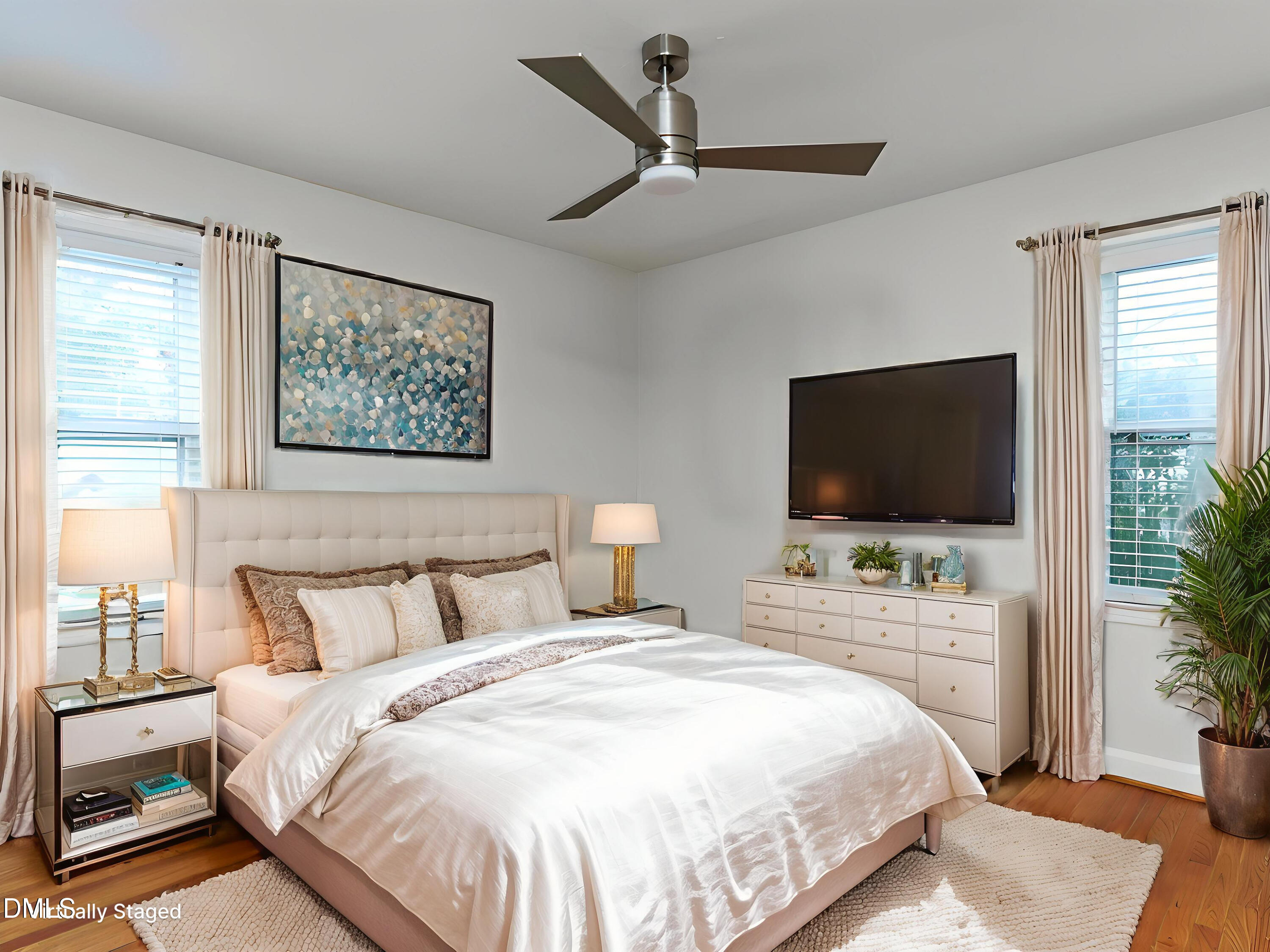 1332 Banbury Road Raleigh, NC 27607 - Photo 27 of 46 a bedroom with a bed a flat screen tv and a couch