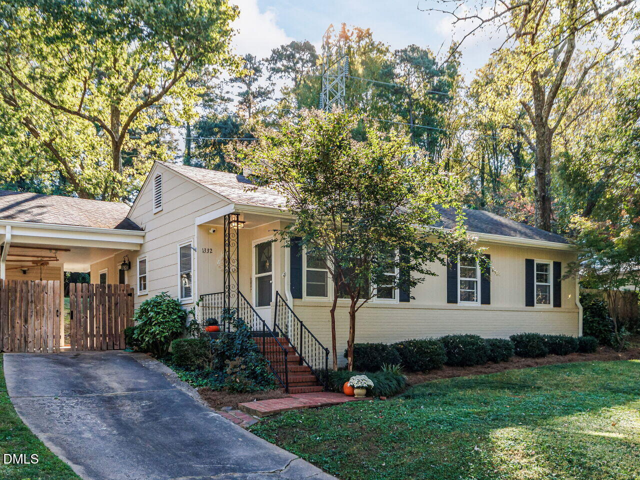 1332 Banbury Road Raleigh, NC 27607 - Photo 2 of 46 a front view of a house with a garden and trees