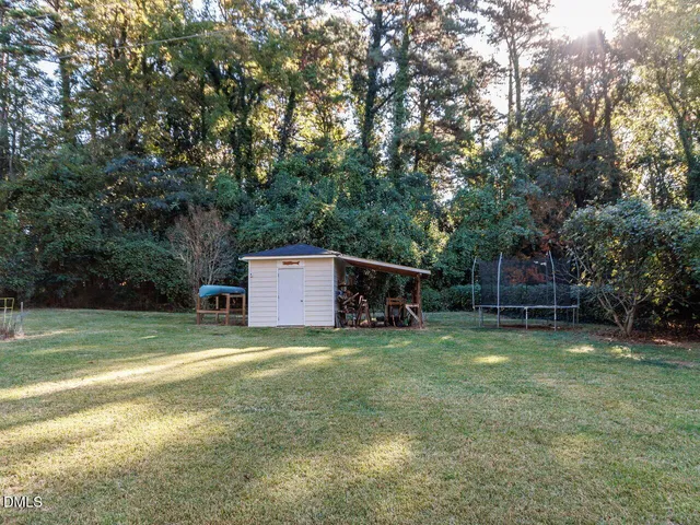 a view of a big yard with basketball court