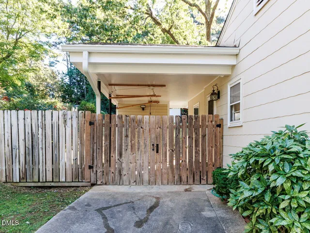 a view of a house with a wooden fence