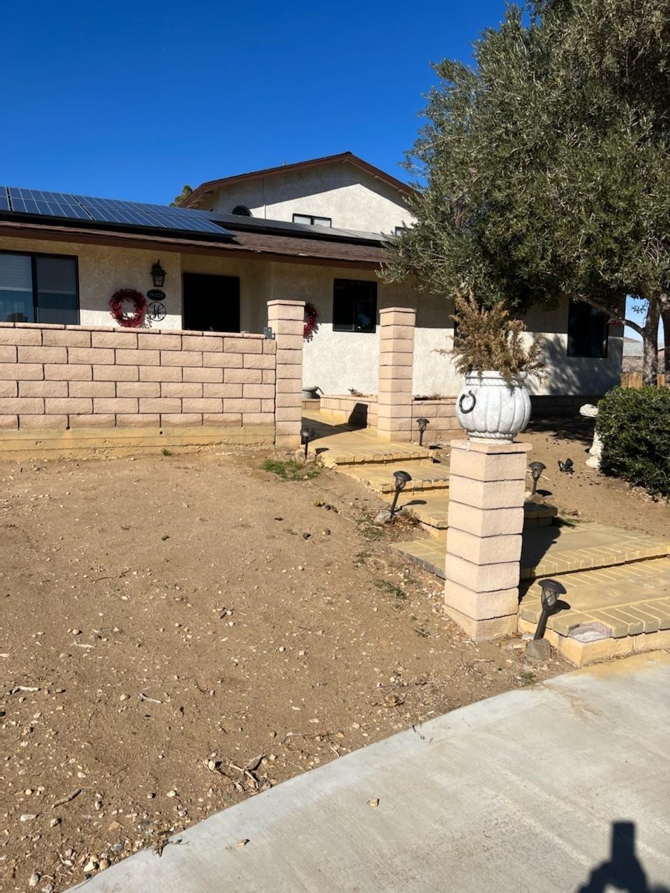 16326 Rancherias Road Apple Valley, CA 92307 - Photo 1 of 1 a view of a backyard with chairs and potted plants