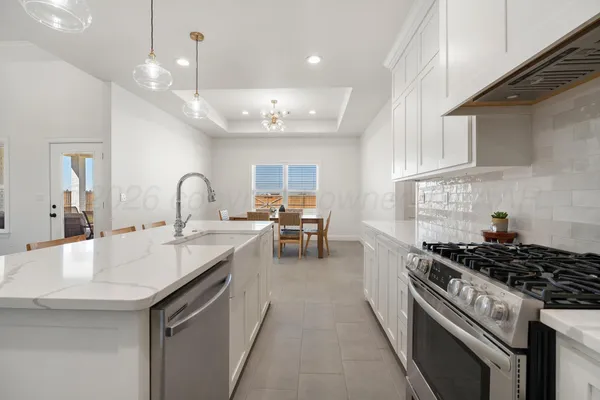 a kitchen with kitchen island a sink stainless steel appliances and cabinets