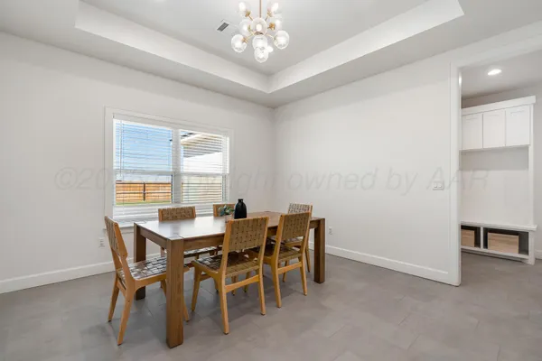 a view of a dining room with furniture and chandelier