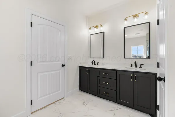 a spacious bathroom with a shower sink and mirror