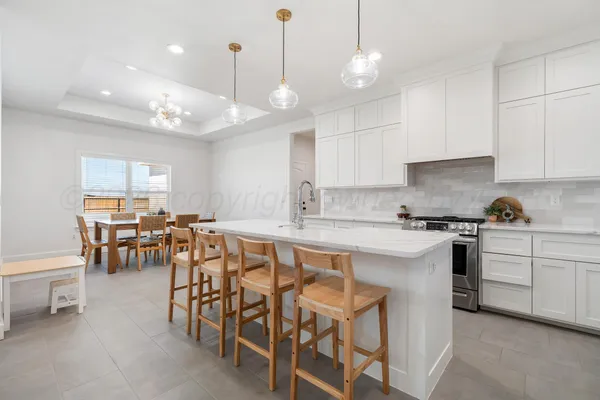 a large kitchen with a table and chairs