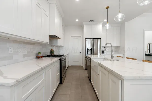 a kitchen with a sink stove and refrigerator