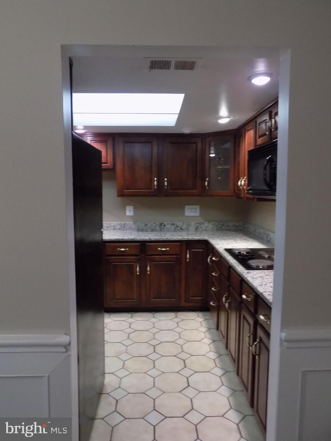 702 Towne Center Drive Joppa, MD 21085 - Photo 15 of 45 a kitchen with stainless steel appliances granite countertop a sink a stove and a refrigerator