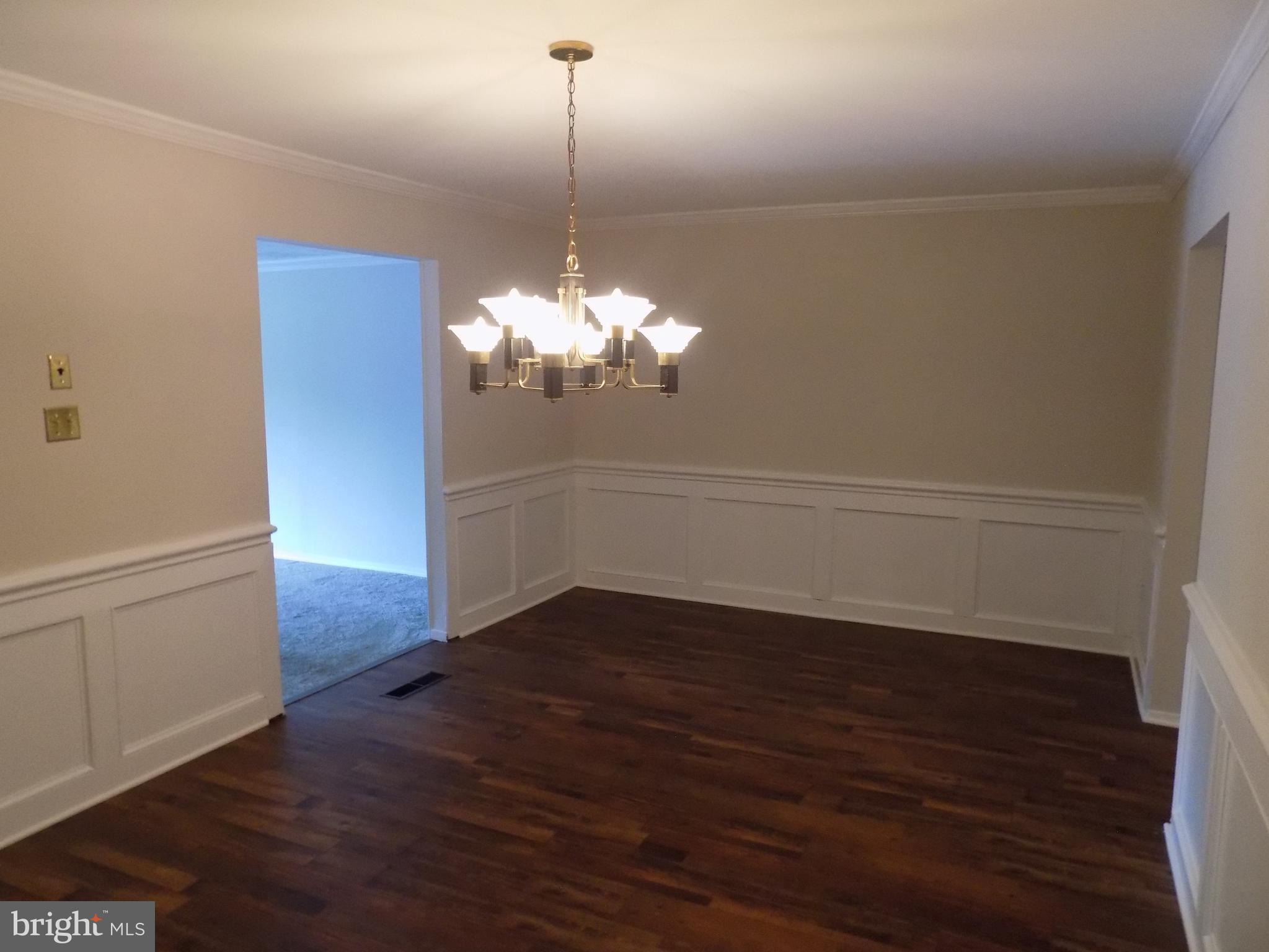 702 Towne Center Drive Joppa, MD 21085 - Photo 19 of 45 a view of a room with wooden floor chandelier and a window