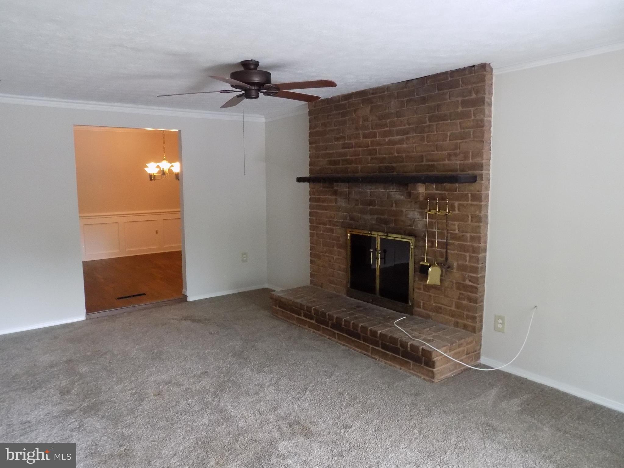 702 Towne Center Drive Joppa, MD 21085 - Photo 21 of 45 an empty room with fireplace and windows