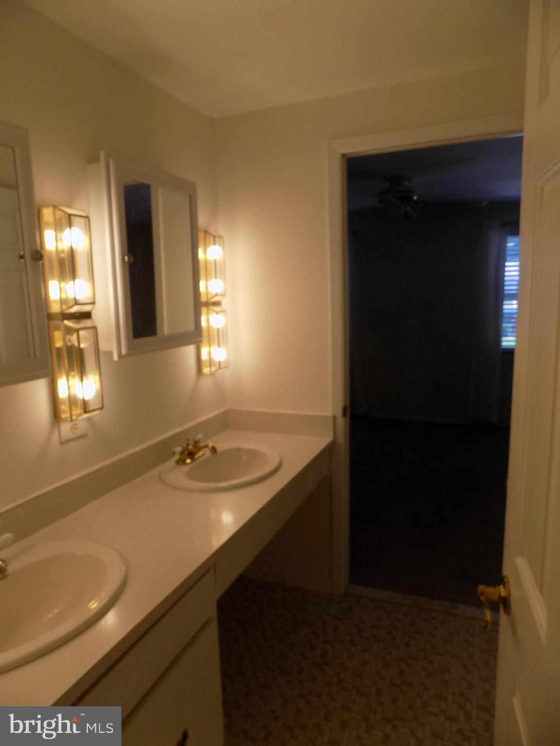 702 Towne Center Drive Joppa, MD 21085 - Photo 38 of 45 a bathroom with a sink and a mirror