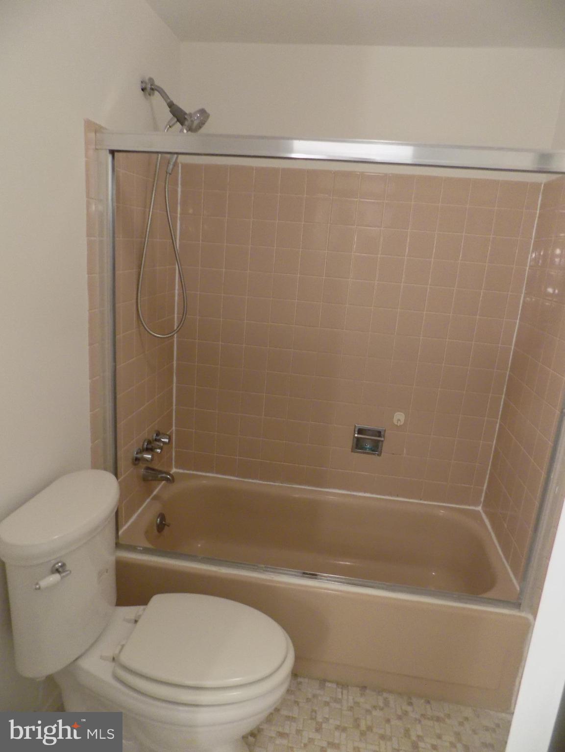 702 Towne Center Drive Joppa, MD 21085 - Photo 40 of 45 a white toilet sitting next to a bath tub