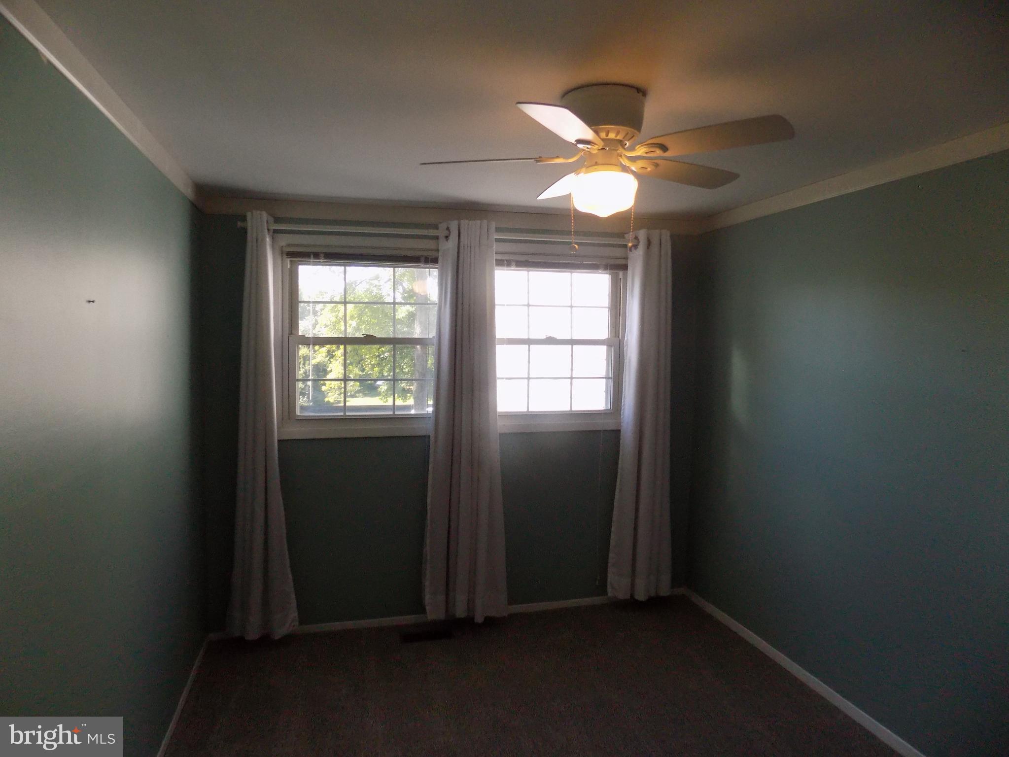 702 Towne Center Drive Joppa, MD 21085 - Photo 44 of 45 an empty room with windows and fan