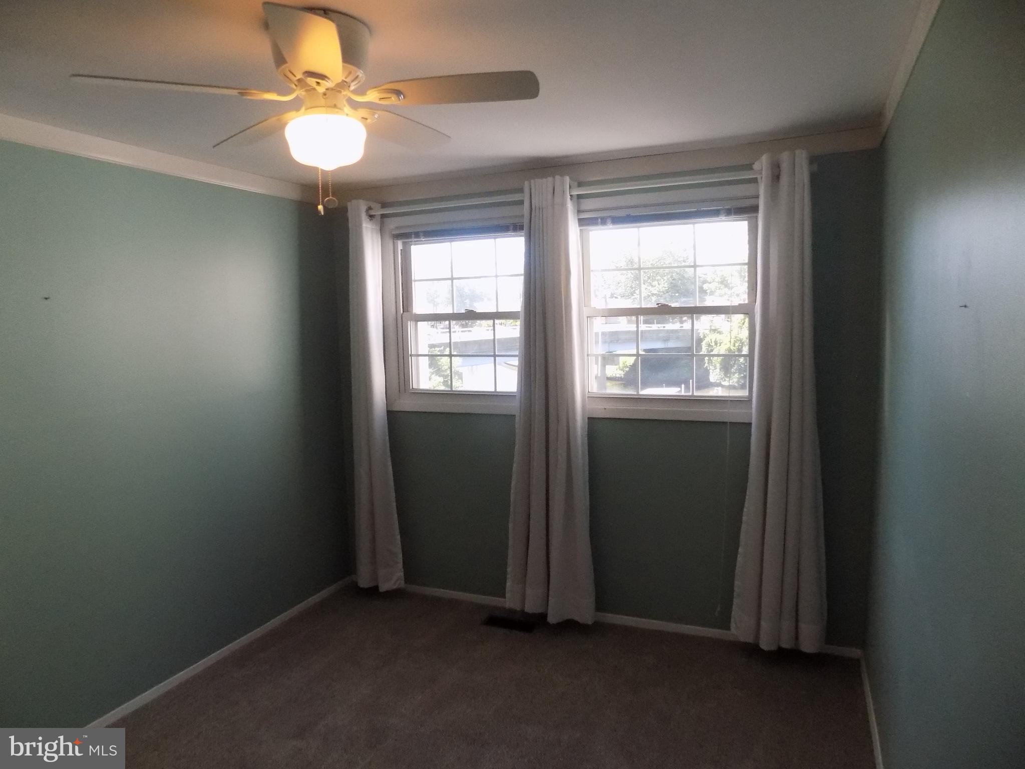 702 Towne Center Drive Joppa, MD 21085 - Photo 45 of 45 an empty room with windows and fan