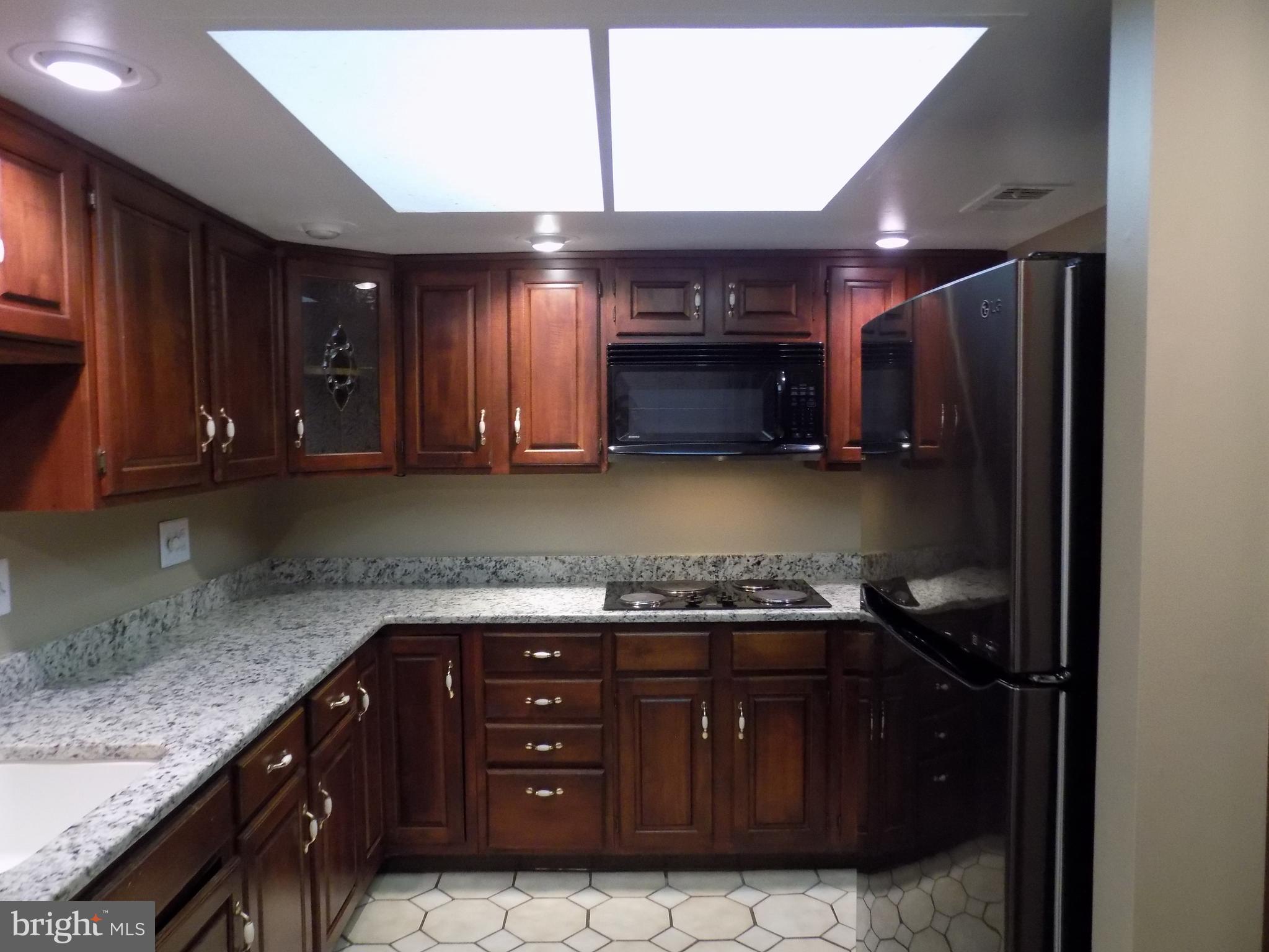 702 Towne Center Drive Joppa, MD 21085 - Photo 7 of 45 a kitchen with a sink and a stove