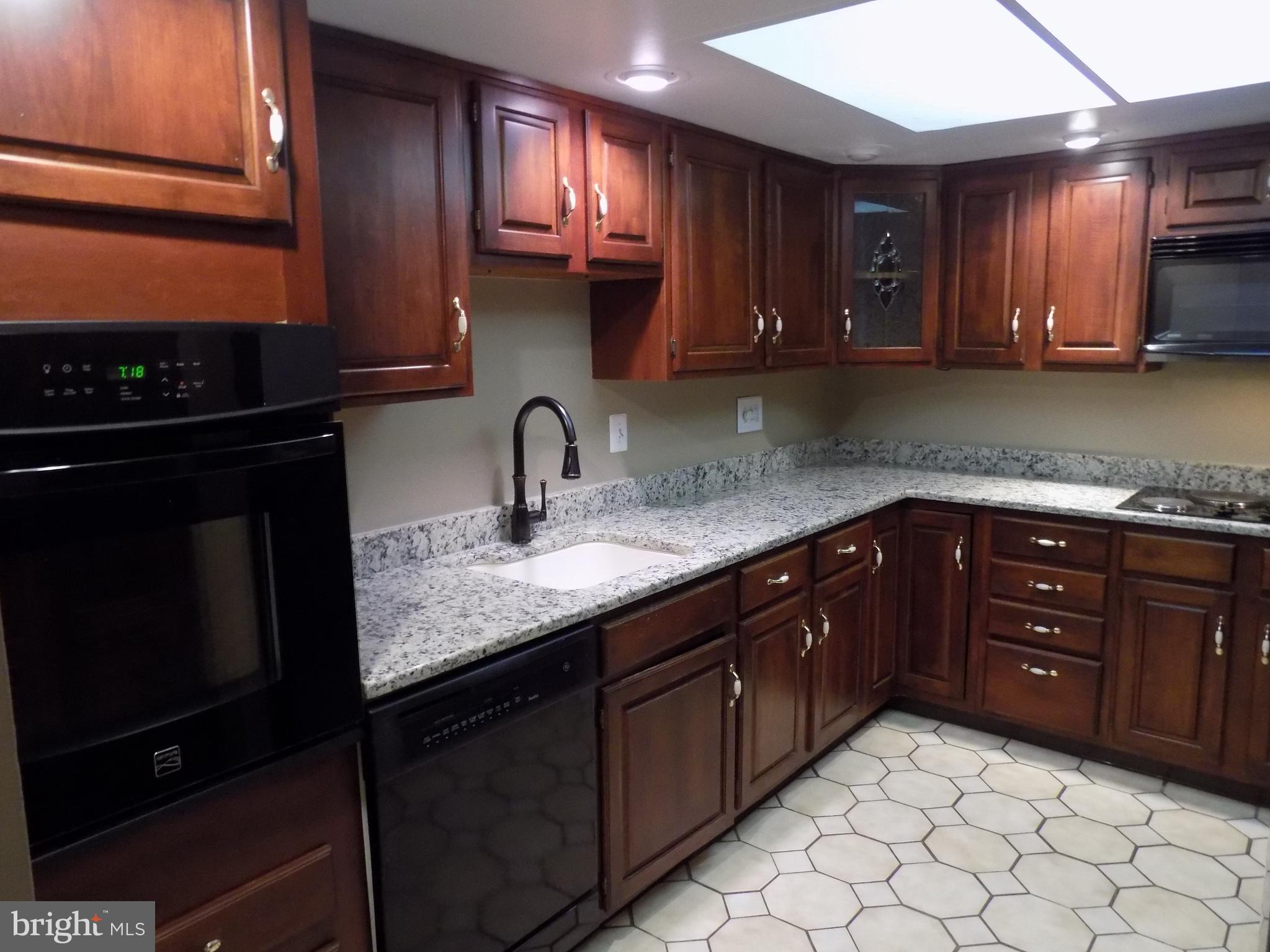 702 Towne Center Drive Joppa, MD 21085 - Photo 8 of 45 a kitchen with a sink and cabinets