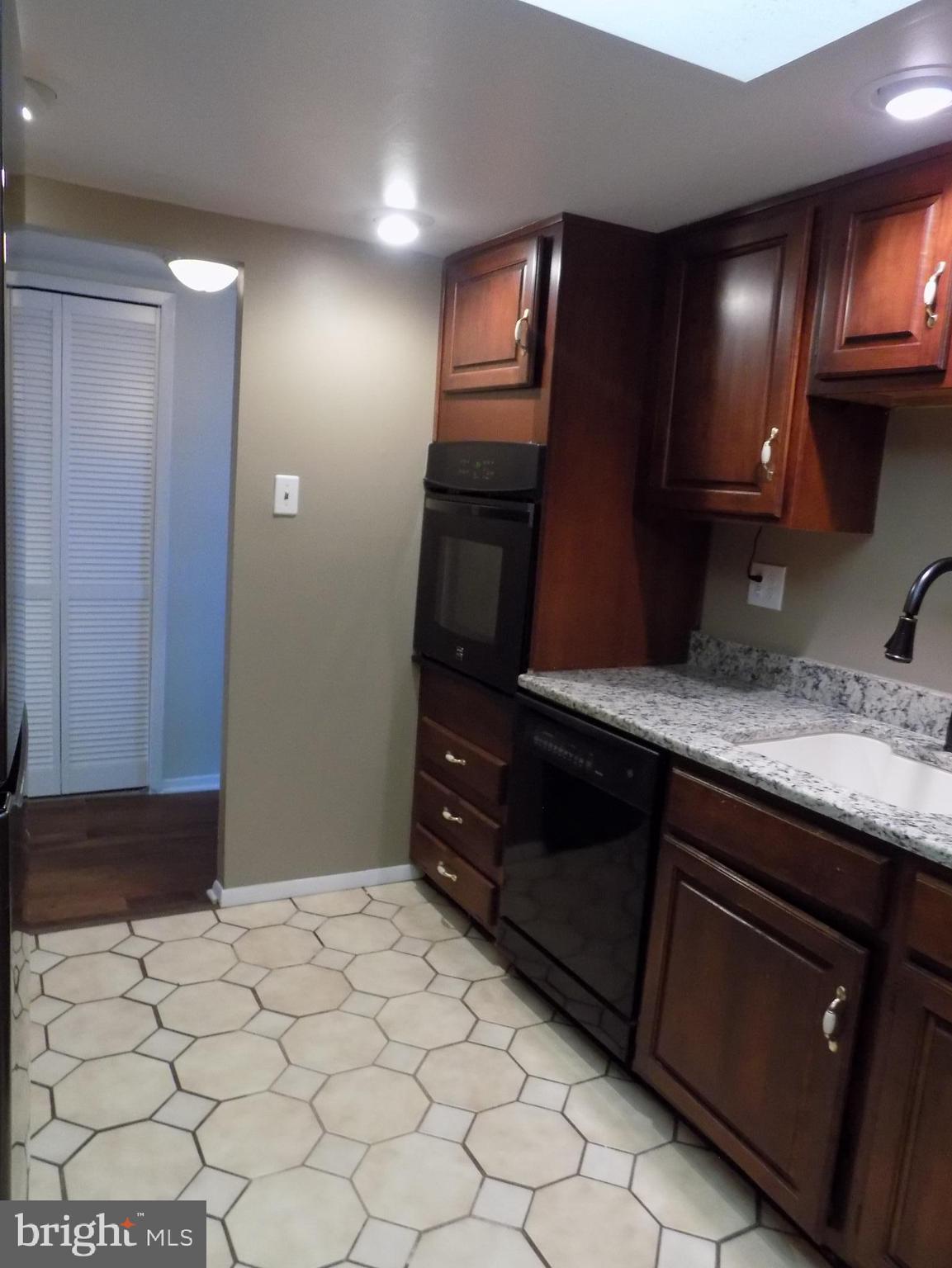 702 Towne Center Drive Joppa, MD 21085 - Photo 10 of 45 a kitchen with a sink and a refrigerator
