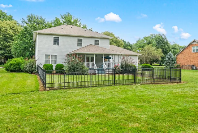 an aerial view of a house with a yard basket ball court and outdoor seating
