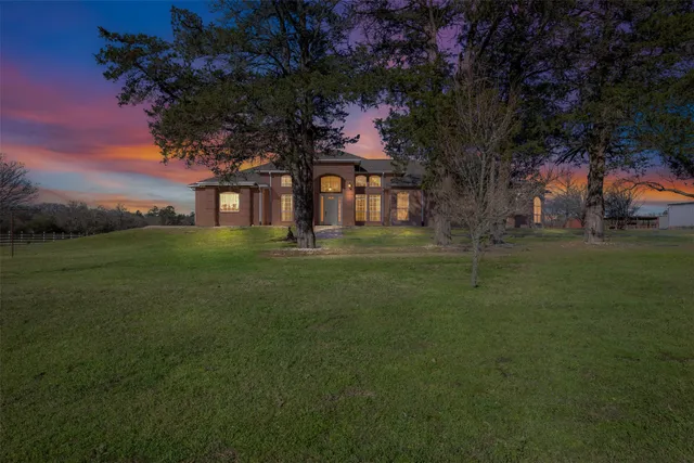 a big house with a big yard and large trees