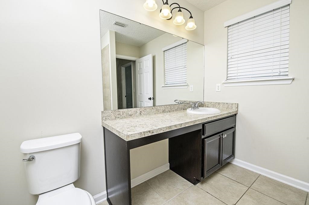 41 Nelson Lane St. Johns, FL 32259 - Photo 20 of 34 a bathroom with a granite countertop sink and a toilet