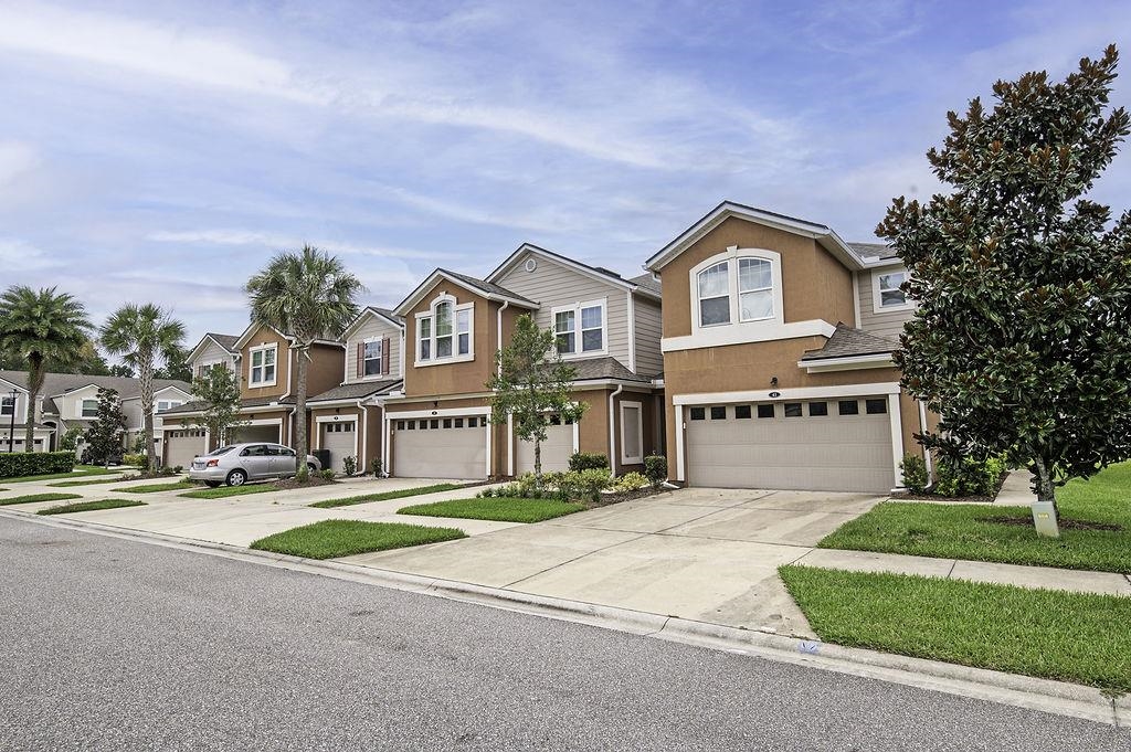 41 Nelson Lane St. Johns, FL 32259 - Photo 2 of 34 a front view of a house with a garden and tree