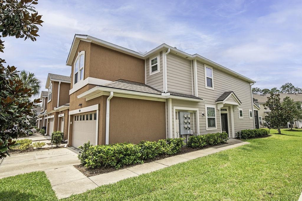 41 Nelson Lane St. Johns, FL 32259 - Photo 3 of 34 a front view of a house with a yard and garage