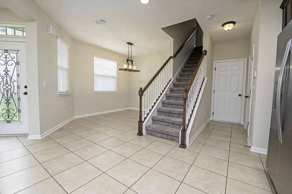 41 Nelson Lane St. Johns, FL 32259 - Photo 6 of 34 an empty room with staircase and windows