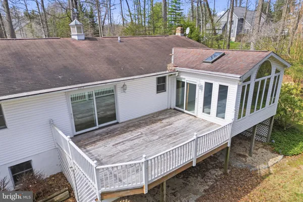 a view of a house with a wooden deck