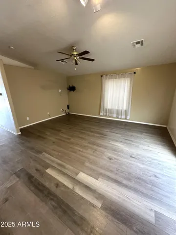 a kitchen with a refrigerator and a stove top oven