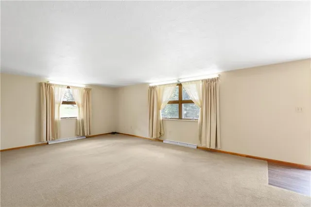 an empty room with windows and entrance