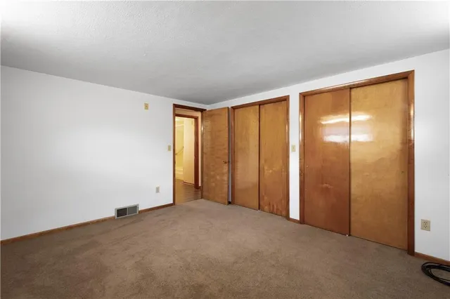 an empty room with painting on the wall