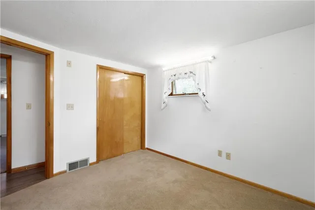 a view of empty room with wooden walls