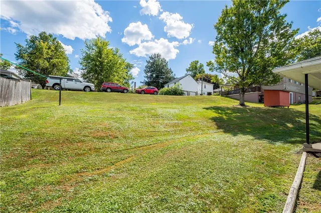 a view of a yard with a house in the background