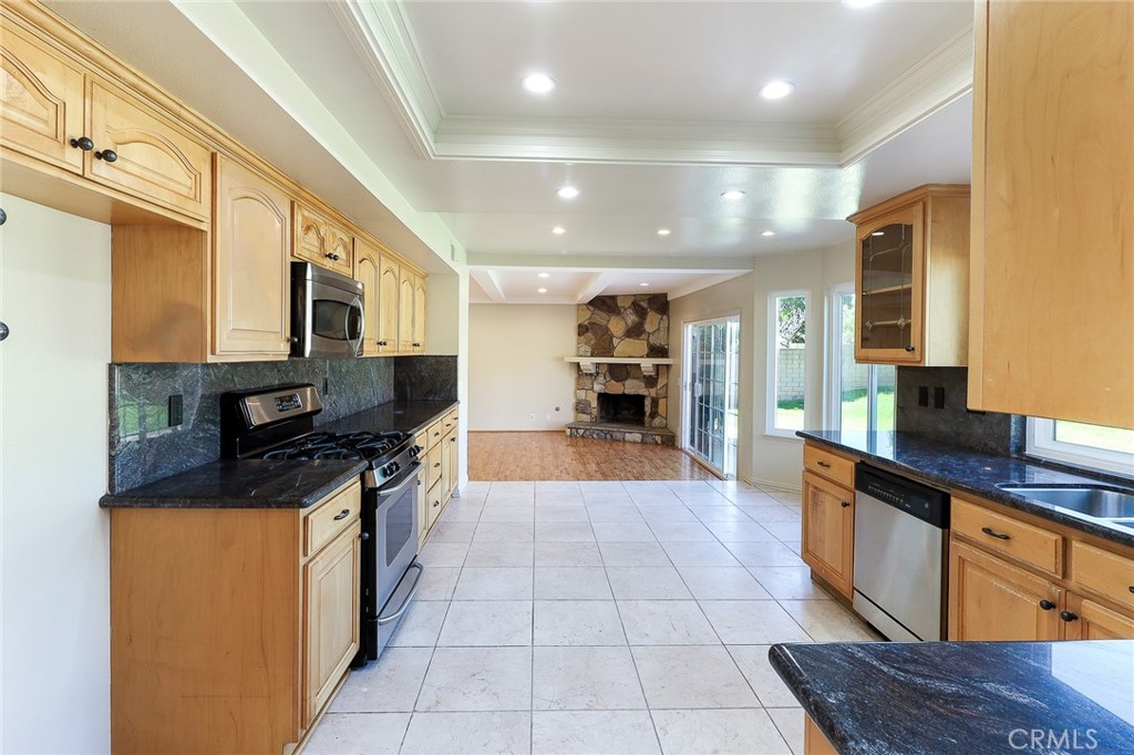 2167 Baseline Road La Verne, CA 91750 - Photo 3 of 7 a large kitchen with stainless steel appliances granite countertop a large counter top a stove and a refrigerator