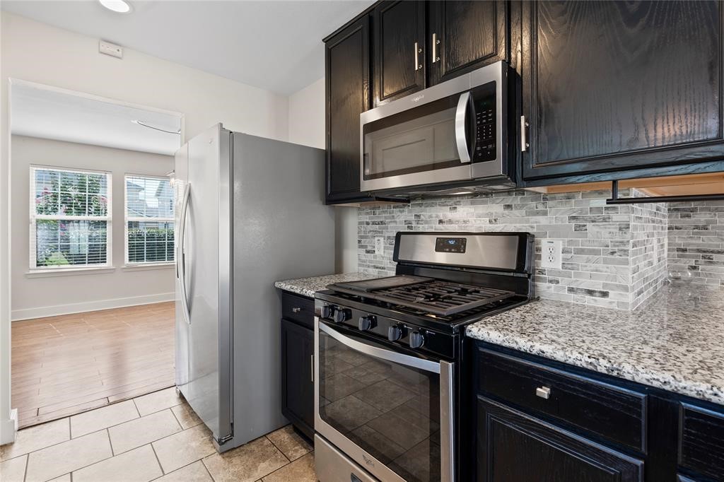 20729 Patriot Park Lane Katy, TX 77449 - Photo 8 of 39 a kitchen with granite countertop cabinets stainless steel appliances and a sink