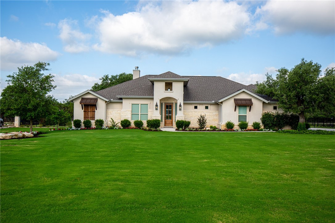 a front view of house with yard and green space