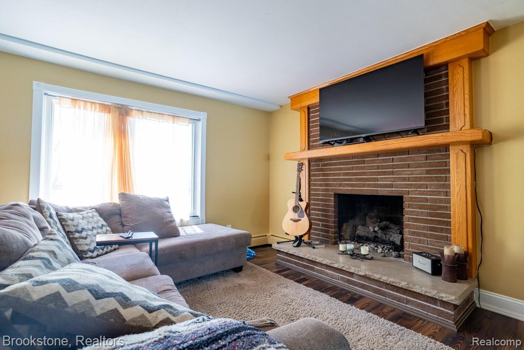 30100 Armada Ridge Road Richmond, MI 48062 - Photo 9 of 29 Living space featuring a brick fireplace with a stone hearth and wood-finish mantel