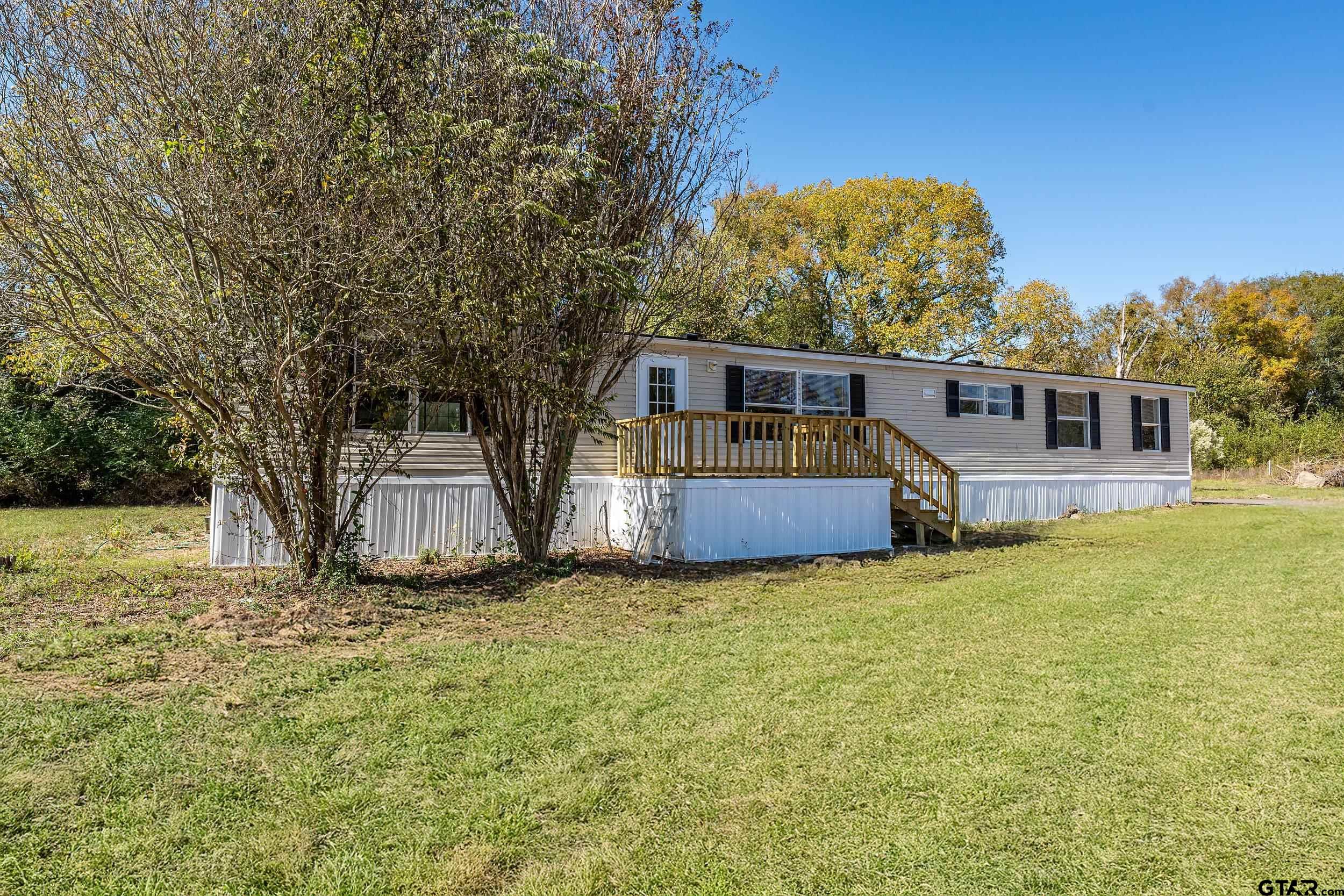 1121 Pecan Ridge Chandler, TX 75758 - Photo 11 of 26 a view of a house with a yard