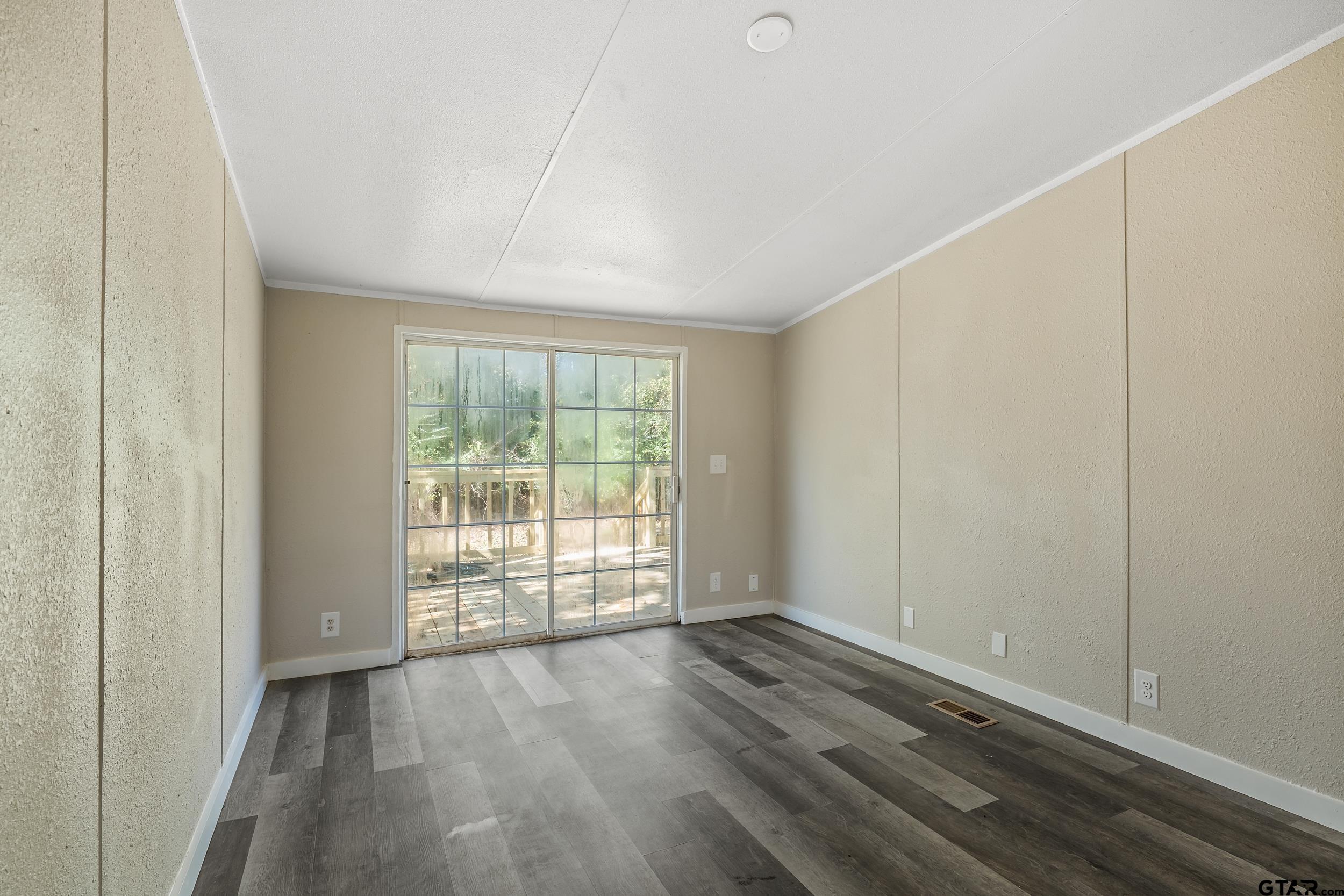 1121 Pecan Ridge Chandler, TX 75758 - Photo 14 of 26 wooden floor in an empty room with a window