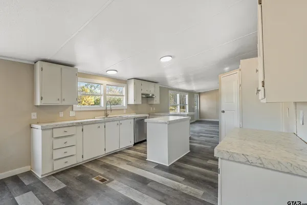 a kitchen with sink and cabinets