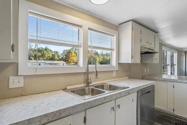 a kitchen with a sink and large window