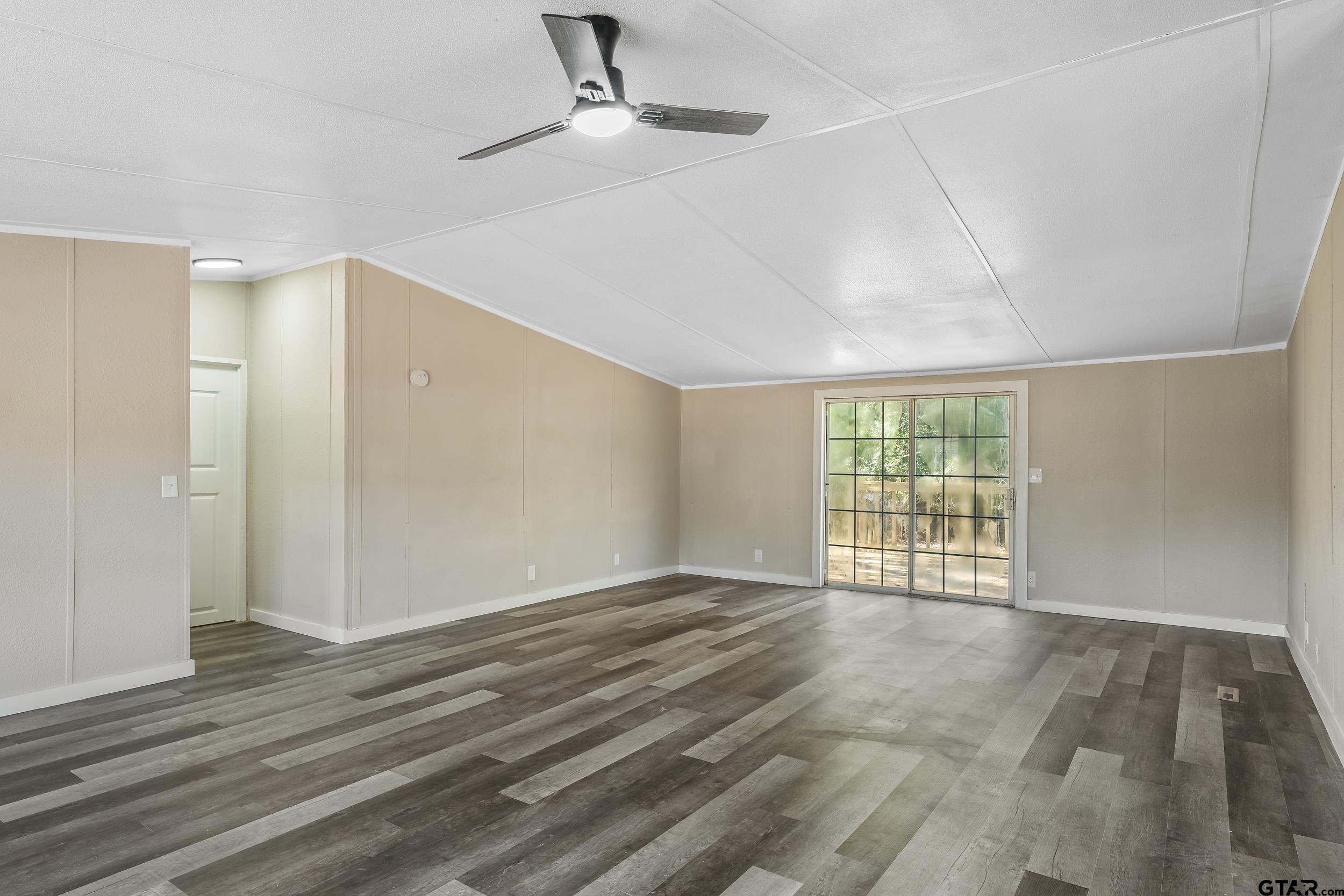 1121 Pecan Ridge Chandler, TX 75758 - Photo 6 of 26 wooden floor in an empty room with a window