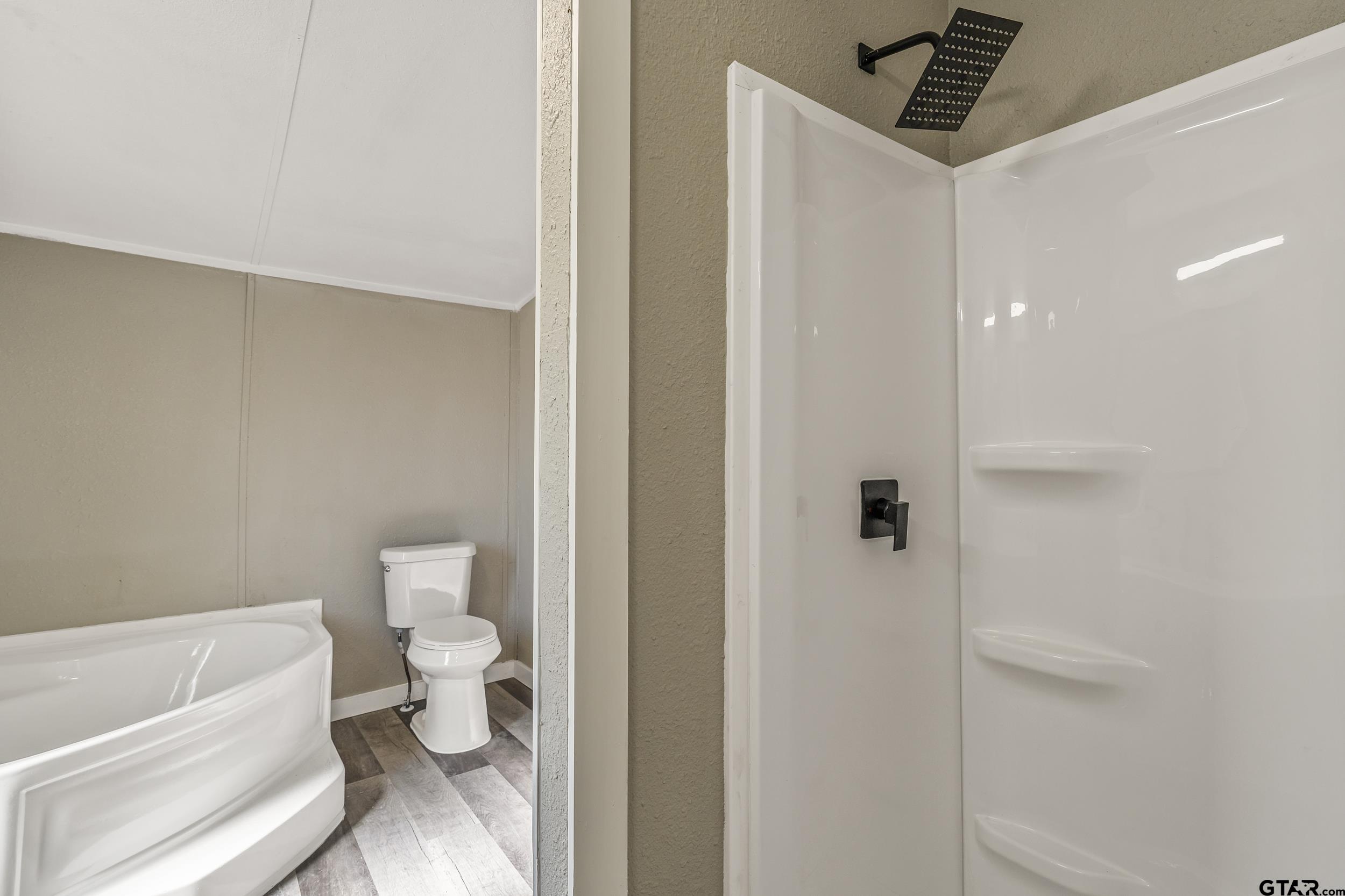 1121 Pecan Ridge Chandler, TX 75758 - Photo 7 of 26 a bathroom with a toilet and a shower