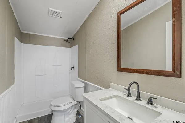 a bathroom with a sink toilet and shower