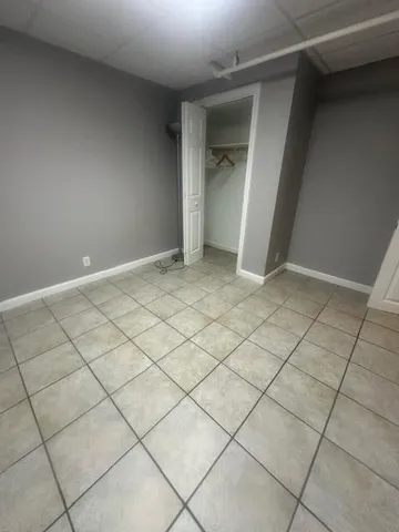 a view of an empty room and wooden shelves