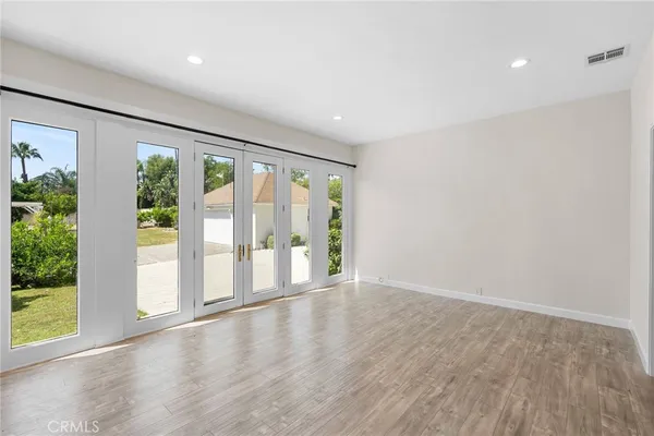 wooden floor in an empty room with a window